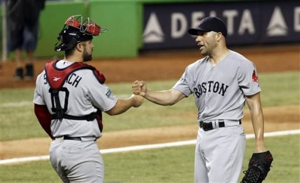 Boston Red Sox relief pitcher Alfredo Aceves, right, is congratulated by catcher Kelly Shoppach after Boston's 2-1 win against the Miami Marlins during an interleague baseball game in Miami, Tuesday, June 12, 2012.