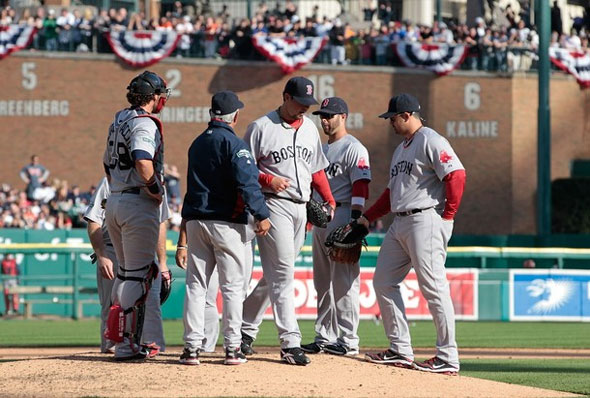 Josh Beckett of the Boston Red Sox is replaced in the fifth inning by manager Bobby Valentine during the game against the Detroit Tigers at Comerica Park on April 7, 2012 in Detroit, Michigan. 