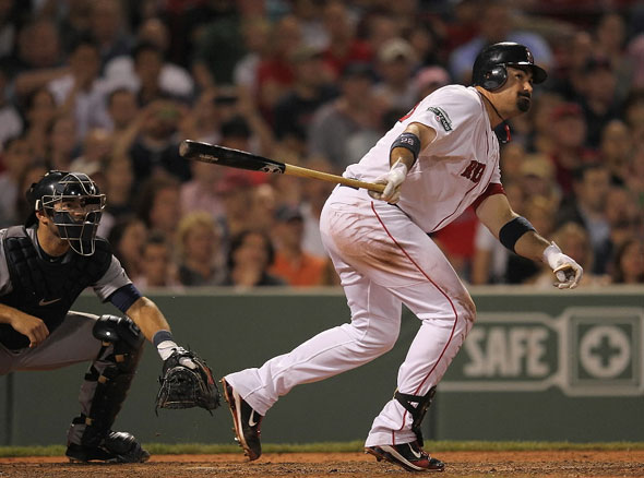 Adrian Gonzalez of the Red Sox doubles to knock in the go-ahead run in the seventh inning against the Detroit Tigers at Fenway Park May 30, 2012 in Boston, Massachusetts.