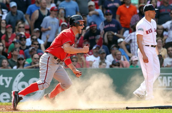 Bryce Harper of the Washington Nationals scores the go-ahead run in the ninth inning as pitcher Alfredo Aceves of the Boston Red Sox looks away during interleague play at Fenway Park June 10, 2012 in Boston, Massachusetts.