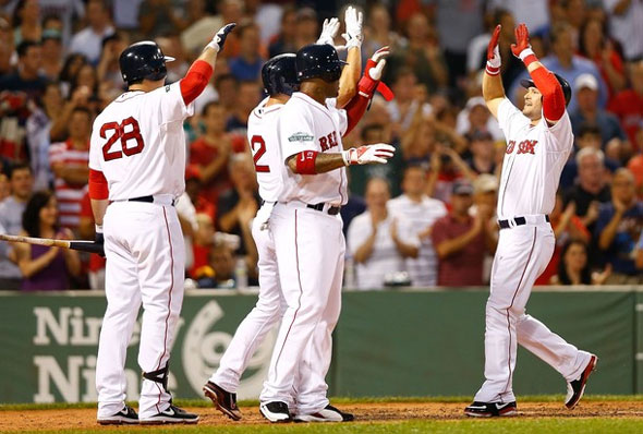 Cody Ross of the Boston Red Sox is congratulated by teammate at home plate after hitting a three run home run against the Chicago White Sox during the game on July 18, 2012 at Fenway Park in Boston, Massachusetts.