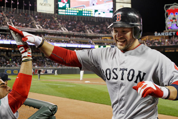 Boston Red Sox' Cody Ross celebrates his two-run, game-tying home run off Minnesota Twins pitcher Jason Marquis in the seventh inning of a baseball game Monday, April 23, 2012, in Minneapolis.