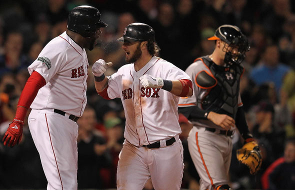 Jarrod Saltalamacchia of the Boston Red Sox celebrates his two-run home run with teammate David Ortiz as Matt Wieters of the Baltimore Orioles looks away in the ninth inning at Fenway Park June 5, 2012 in Boston, Massachusetts.