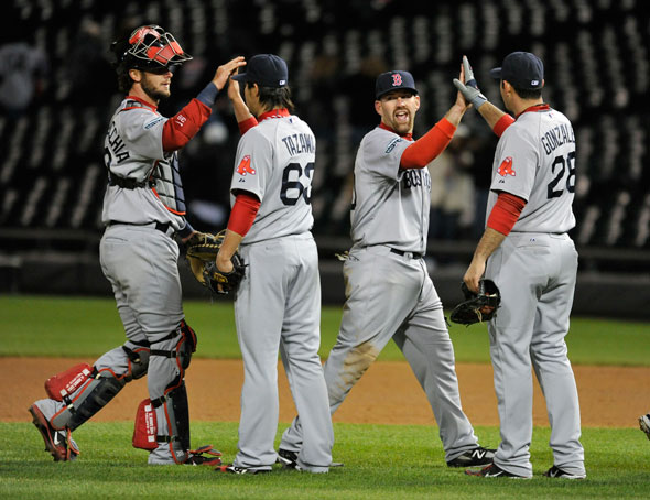 Jarrod Saltalamacchia, Junichi Tazawa, Kevin Youkilis and Adrian Gonzalez of the Boston Red Sox celebrate their win over the Chicago White Sox at U.S. Cellular Field on April 26, 2012 in Chicago, Illinois. The Red Sox defeated the White Sox 10-3.