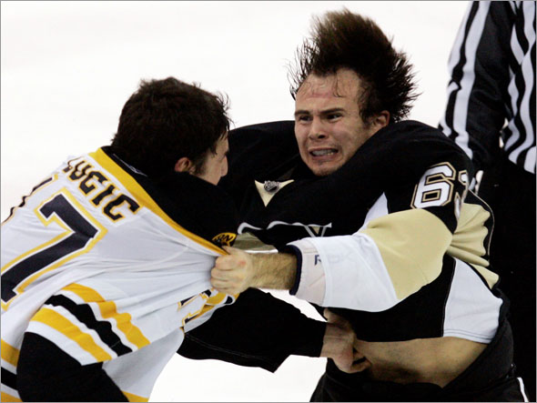 Pittsburgh Penguins' Tim Wallace, right, fights with Boston Bruins' Milan Lucic during the third period of an NHL hockey game in Pittsburgh on Tuesday, Dec. 30, 2008. The Bruins won 5-2.