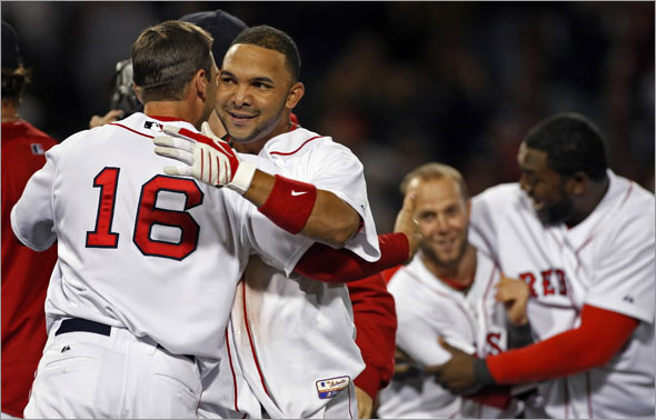 Alex Gonzalez broke an 8-8 bottom of the ninth inning tie with a bases loaded two out single that won the game 9-8. Here he gets a hug at left from teammate George Kottaras, while in the backround right Dustin Pedroia and David Ortiz celebrate together.