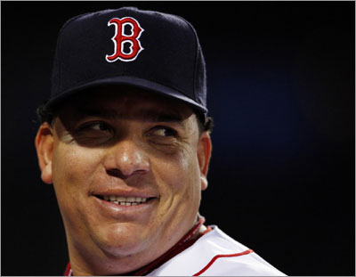 Red Sox pitcher Bartolo Colon smiles as he walks to the dugout in the third inning of the Red Sox MLB baseball game against the Kansas City Royals at Fenway Park in Boston, Massachusetts May 21, 2008. It is Colon's first start with the Red Sox.