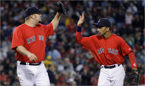 Sox starter Brad Penny, left, high-fives shortstop Julio Lugo after a line out by Texas Rangers Hank Blalock in the fourth inning of a baseball game at Fenway Park in Boston, Friday June 5, 2009.