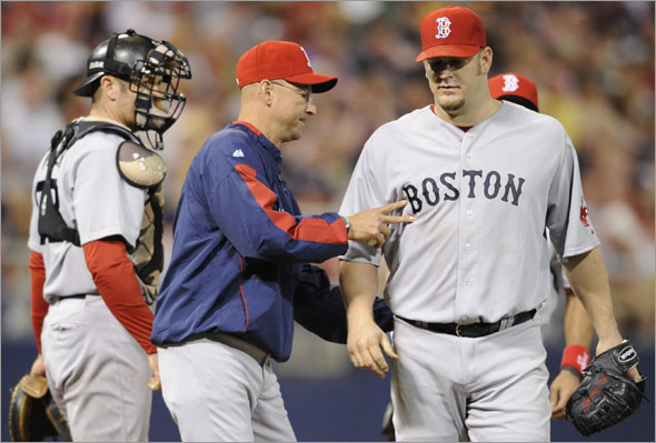 Red Sox manager Terry Francona removes Brad Penny, right, in the sixth inning of a baseball game against the Minnesota Twins, Monday, May 25, 2009, in Minneapolis. Red Sox won 6-5. Penny (5-1) pitched his third straight victory.