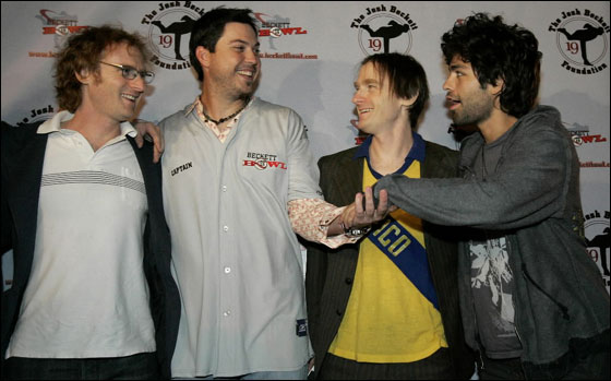 Red Sox pitcher Josh Beckett shakes hands with actor and Honey Brothers band member Adrian Grenier as fellow band members Ari Gold and Ethan Gold look on at the inaugural Beckett Bowl at Town Line Lanes in Malden