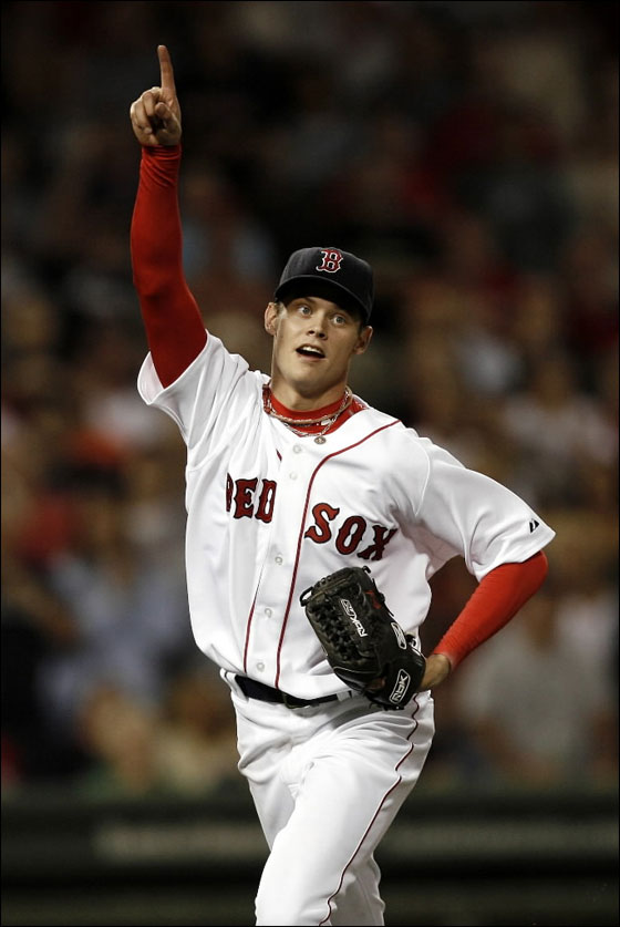  Red  Sox pitcher  Clay Buchholz points toward a pop-up to teammate Kevin Youkilis during the seventh inning against the Baltimore Orioles in a baseball game at Fenway Park in Boston on Saturday, Sept. 1, 2007.