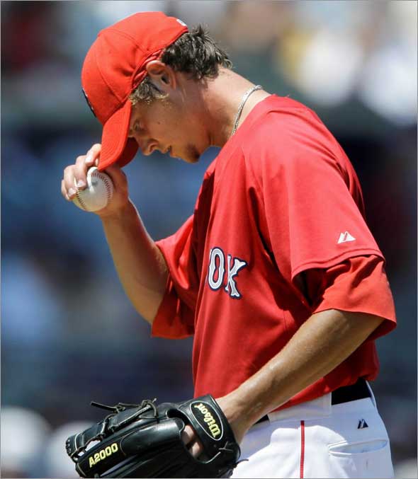 Boston Red Sox starter Clay Buchholz tugs on his cap after giving up his second two-run home run against Tampa Bay Rays in the fourth inning during their spring training baseball game in Fort Myers, Fla., Tuesday March 31, 2009. Buchholz lasted 5 1/3 innings, giving up six earned runs on nine hits.