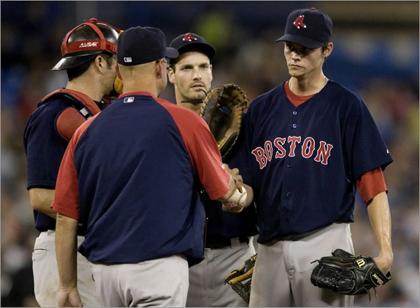 Boston Red Sox pitcher Clay Buchholz hands the ball to manager Terry Francona during the sixth inning of a baseball game against the Toronto Blue Jays in Toronto on Friday, July 17, 2009. (AP Photo/The Canadian Press, Darren Calabrese)