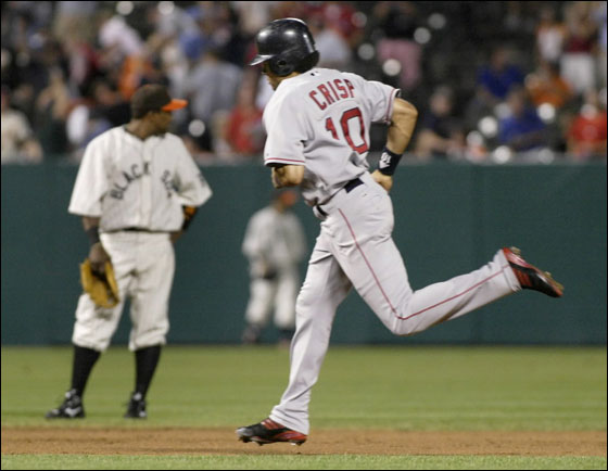 Red Sox base runner Coco Crisp rounds the bases past Baltimore Orioles shortstop Miguel Tejada after hitting a three-run home run off Baltimore Orioles starting pitcher Garrett Olson in the fourth inning of their MLB American League baseball game in Baltimore