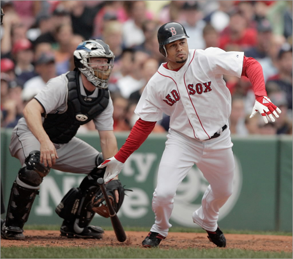 Boston Red Sox's Coco Crisp, right, hits an RBI-single in front of Toronto Blue Jays catcher Gregg Zaun, left, in the second inning of a baseball game, Sunday, Sept. 14, 2008, in Boston. The Red Sox won 4-3.