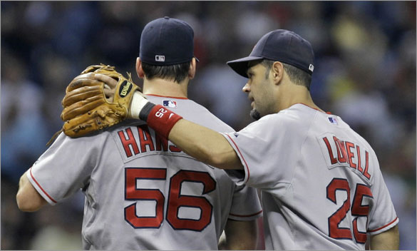 Red Sox third baseman Mike Lowell, right, talks with pitcher Craig Hansen after he surrendered the lead to the Tampa Bay Rays during the seventh inning of a baseball game Wednesday, July 2, 2008, in St. Petersburg, Fla.