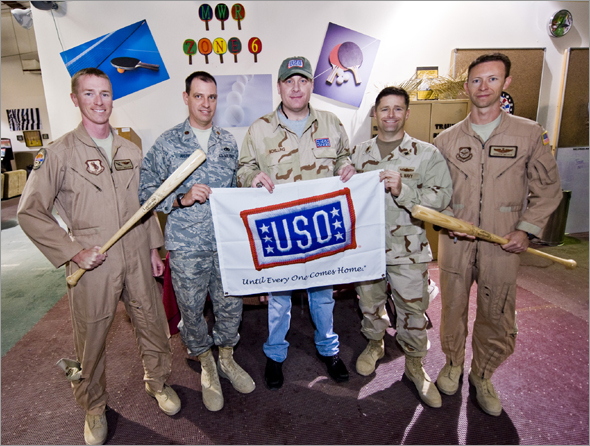 Six-time major league baseball All-Star Curt Schilling poses for a photo with troops as part of a week-long USO tour to the Persian Gulf. Taking the mound to extend America�s well wishes, Schilling will visit and shake hands with troops, sign autographs and pose for pictures.