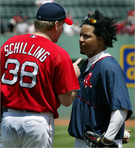 7-11-2004: Prior to the Red Sox-Rangers game, during batting practice, pitcher Curt Schilling (left) had a rather long, animated conversation with teammate Manny Ramirez (right), who asked out of the starting lineup, sighting a hamstring problem.