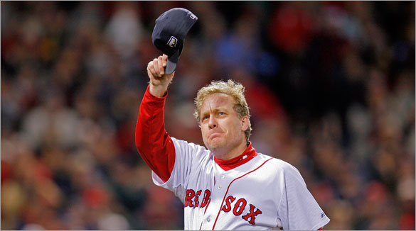 An emotional Red Sox starting pitcher Curt Schilling tips his cap to the crowd (perhaps for the last time in Boston) as he leaves the game in the sixth inning.