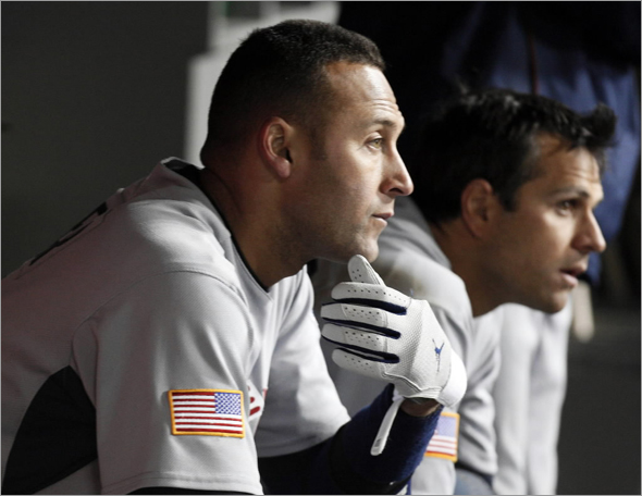 Team USA's Derek Jeter sits in the dugout during the ninth inning of their semifinals of the World Baseball Classic against Team Japan in Los Angeles, California March 22, 2009. Team Japan defeated Team USA.