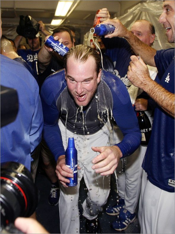 Los Angeles Dodgers pitcher Derek Lowe celebrates in the club house after sweeping the Chicago Cubs to win Game 3 of their MLB National League Divisional Series playoff baseball game in Los Angeles, October 4, 2008.
