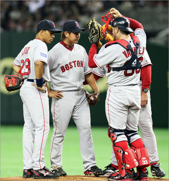 Pitcher Daisuke Matsuzaka talks to teammates in the second innings during the MLB Opening Series between Boston Red Sox and Oakland Athletics at Tokyo Dome on March 25, 2008 in Tokyo, Japan.