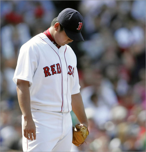 Red Sox starting pitcher Daisuke Matsuzaka of Japan hangs his head as he is taken out of the game against the Texas Rangers during the sixth inning of their American League MLB baseball game at Fenway Park in Boston, Massachusetts June 7, 2009. 