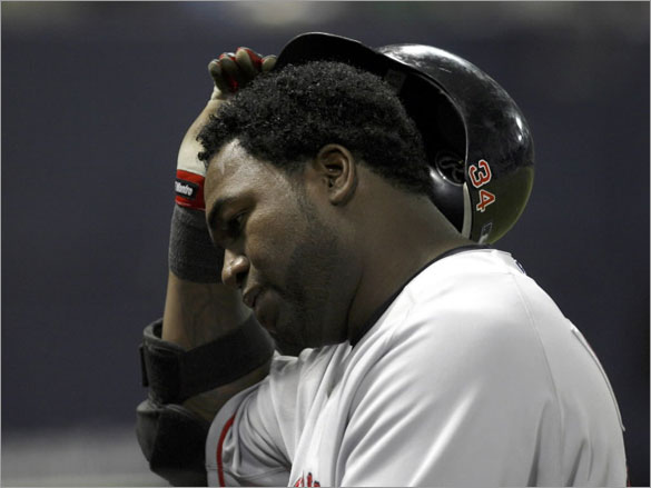 Red Sox David Ortiz takes off his helmet as he walks back to the dugout after popping up to Minnesota Twins Mike Lamb with men on base during the fifth inning of their American League baseball game at the Metrodome in Minneapolis, May 12, 2008