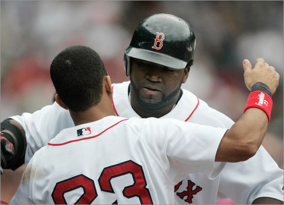  Julio Lugo, left, hugs teammate David Ortiz after Ortiz's solo home run in the third inning of a baseball game against the Milwaukee Brewers, Sunday, May 18, 2008, in Boston.