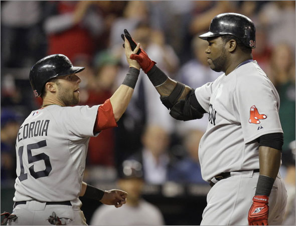 David Ortiz, right, celebrates with Dustin Pedroia (15) after Ortiz hit a three-run home run during the eighth inning of a baseball game against the Kansas City Royals on Wednesday, Sept. 23, 2009, in Kansas City, Mo. 