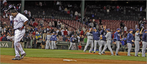 The Rays (right) celebrate and David Ortiz (left) doesn't after the last out of the game.