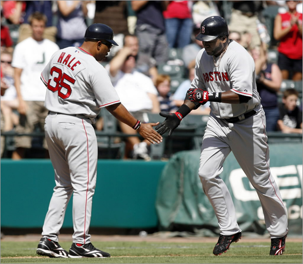 Red Sox designated hitter David Ortiz (R) is congratulated by third base coach DeMarlo Hale after hitting a two-run homerun against the Texas Rangers in the fifth inning of their MLB American League baseball game in Arlington, Texas September 7, 2008.