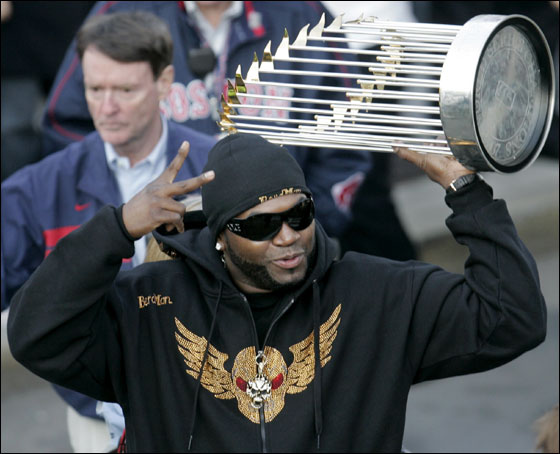 Boston Red Sox's David Ortiz holds up the World Series trophy in front of a crowd outside Boston's Fenway Park moments after returning from Denver, Monday, Oct. 29, 2007. The Red Sox beat the Colorado Rockies, 4-3, in Game 4 Sunday, Oct. 28, 2007, at Coors Field in Denver, to sweep the series 4-0.
