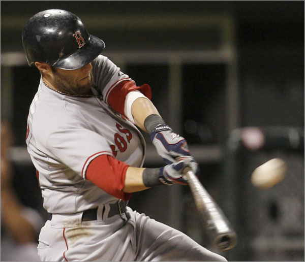 Red Sox's Dustin Pedroia hits a three-run home run against the Chicago White Sox during the eighth inning of a baseball game Friday, Aug. 8, 2008, in Chicago.