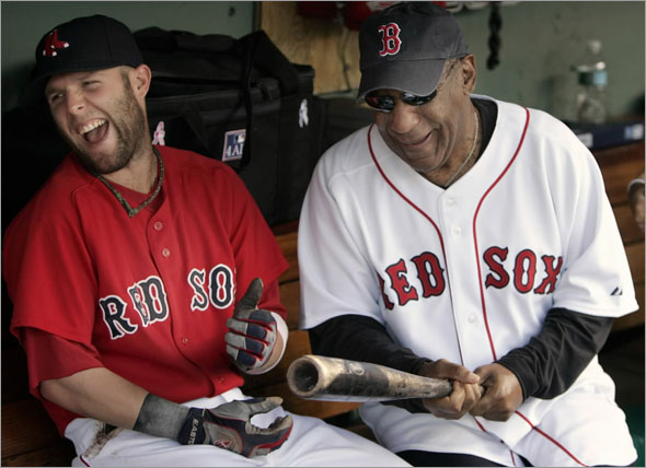 Bill Cosby jokes with Boston Red Sox second baseman Dustin Pedroia before taking on the Kansas City Royals in their MLB American League baseball game at Fenway Park in Boston, Massachusetts July 10, 2009.
