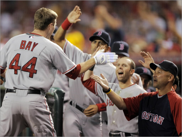 Jason Bay is congratulated by teammates after hitting a two-run home run during the sixth inning of Game 1 of baseball's American League division series against the Los Angeles Angels in Anaheim, Calif., Wednesday, Oct. 1, 2008.