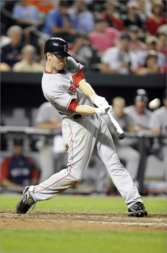Jason Bay of the Boston Red Sox hits a home run in the eighth inning against the Baltimore Orioles August 18, 2008 at Camden Yards in Baltimore, Maryland. (