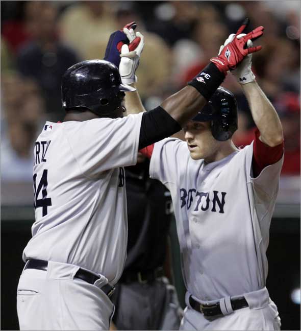 Jason Bay, right, is congratulated by David Ortiz after Bay hit a three-run home run off Cleveland Indians pitcher Kerry Wood in the ninth inning of a baseball game, Monday, April 27, 2009, in Cleveland. Ortiz and Dustin Pedroia scored. The Red Sox won 3-1.