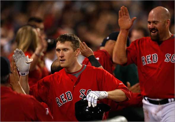 Boston Red Sox left fielder Jason Bay is congratulated in the dugout after his 2 run HR off New York Yankees relief pitcher Mariano Rivera (42), not pictured, tied the game at 4-4 in the 9th.