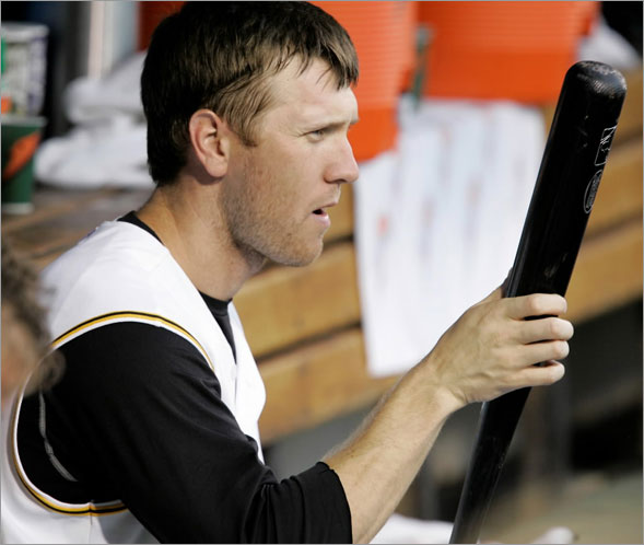 Jason Bay sits on the bench with his bat during the third inning of a baseball game against the Colorado Rockies in Pittsburgh Wednesday, July 30, 2008.