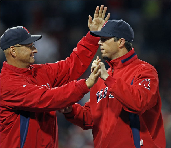 Red Sox manager Terry Francona (left) has a smile and a pat on the head for winning pitcher  Josh  Beckett during the post game congratulations on the field. The Boston Red Sox play the New York Yankees at Fenway Park. 