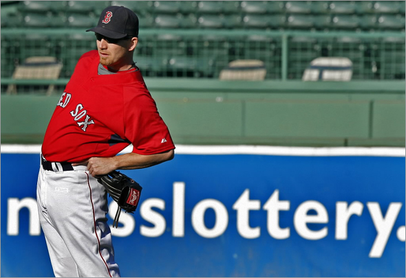 J.D. Drew is shown here stretching his back while shagging in the outfield during batting practice before Tuesday night's playoff clinching game at Fenway Park vs. the Indians.