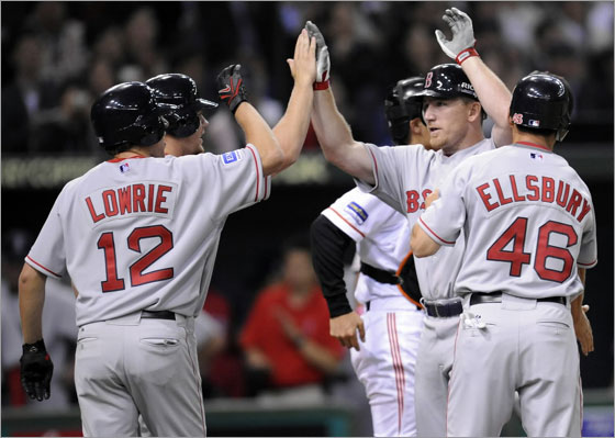 Boston Red Sox J.D. Drew is congratulated by team mates after he blast a grand slam home run during the sixth inning of their exhibition baseball game against the Yomiuri Giants in Tokyo March 23, 2008.