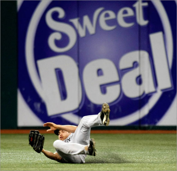 Jacoby Ellsbury makes a sliding catch robbing Tampa Bay Rays' Jason Bartlett of a hit during the eighth inning of a baseball game Tuesday 