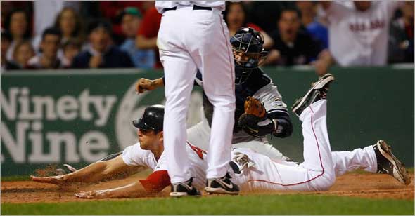 Red Sox's Jacoby Ellsbury steals home under the tag of New York Yankees catcher Jorge Posada during the fifth inning