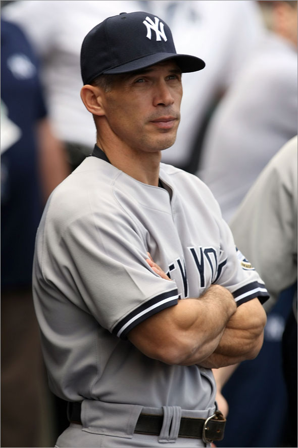 Manager Joe Girardi of the New York Yankees looks on during the Nation Anthem prior to the start of Game Three of the ALCS against the Los Angeles Angels of Anaheim during the 2009 MLB Playoffs at Angel Stadium on October 19, 2009 in Anaheim, California.