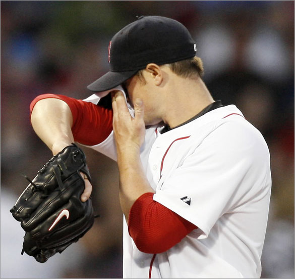 Red Sox pitcher Jon Lester wipes his face after giving up an RBI single during the third inning against the Los Angeles Angels in a baseball game at Fenway Park in Boston Wednesday, April 23, 2008. Lester gave up nine hits and four runs over five innings.