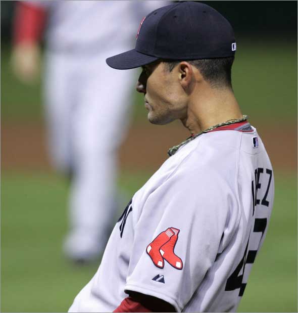 Javier Lopez watches the Cleveland Indians celebrate after the Indians won 9-8 in the ninth inning on an error by Lopez in a baseball game, Tuesday, April 28, 2009, in Cleveland. 