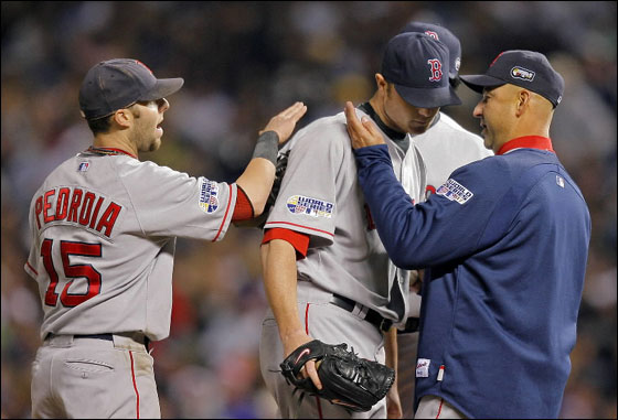 Red Sox starting pitcher Jon Lester gets a word and a pat on the cheek from manager Terry Francona, and a pat on the back from Dustin Pedroia when he was remove3d from the game in the sixth inning.