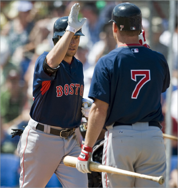 Boston Red Sox' J.D. Drew congratulates Jed Lowrie after Lowrie's solo home run off Toronto Blue Jays starter Roy Halladay during the third inning of a MLB spring training exhibition baseball game in Dunedin, Florida March 16, 2009.